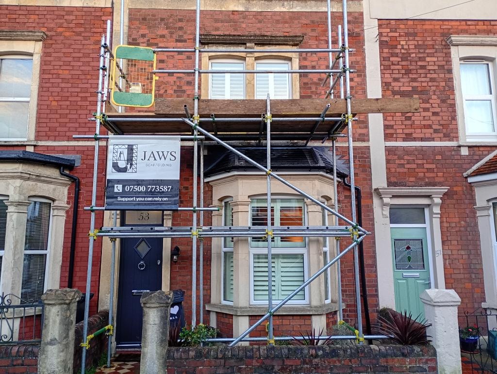 Brick terrace scaffolding with JAWS sign
